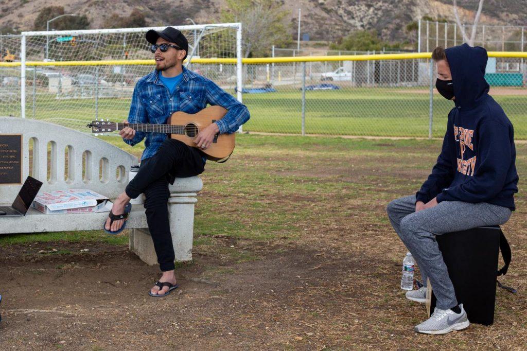 Wiese plays the cajón with Ko Ku, the Vintage worship leader, at Malibu Bluffs Park across the street from campus in March. Wiese said he also plays the violin and was in drumline in high school, but focuses on playing the cajón now because it is more worship-oriented.