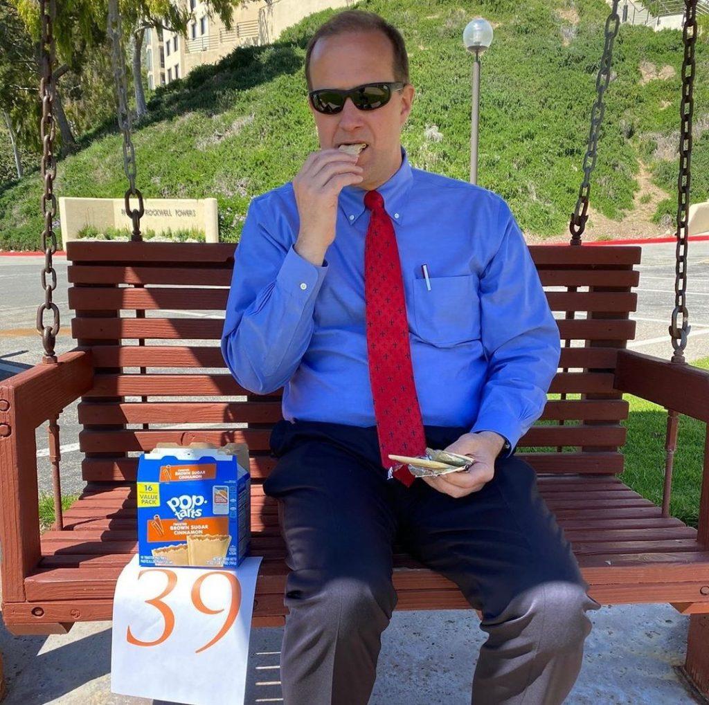 President Jim Gash eats Pop-Tarts on the Banowsky swing bench in spring 2020. While Gash called this "the DTR bench," he is in fact mistaken, as this is just A DTR bench, not THE DTR bench. Photo Courtesy of Jim Gash