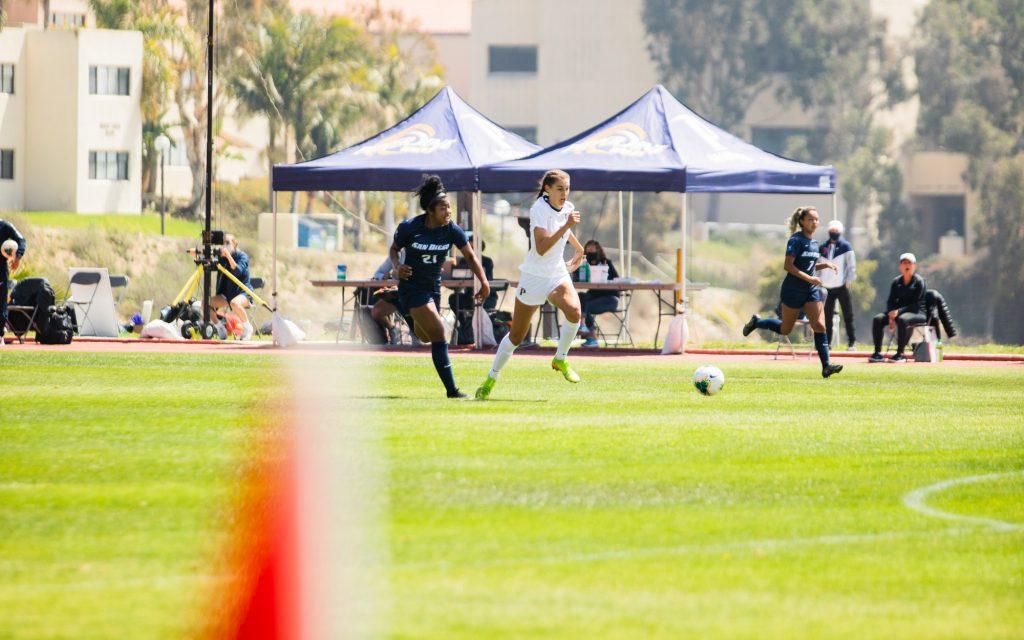 Anderson flies past San Diego sophomore defender Sydney Hopkins during the first half Saturday in Malibu. Anderson scored her second goal of the match on the play.