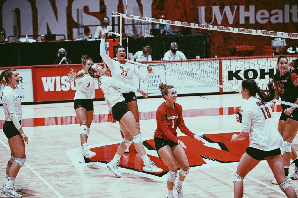 Kraft celebrates by picking up redshirt senior outside hitter Molly Haggerty in a Feb. 6 victory against Rutgers. Wisconsin has seven All-Conference players this season.