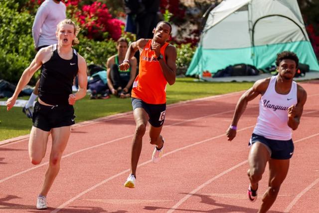 Senior Brandon Davis gains ground against two runners in the 400-meter April 10. Davis broke the school record by .68 seconds the following week at the Bryan Clay Invitational, clocking in at 50.00 seconds.