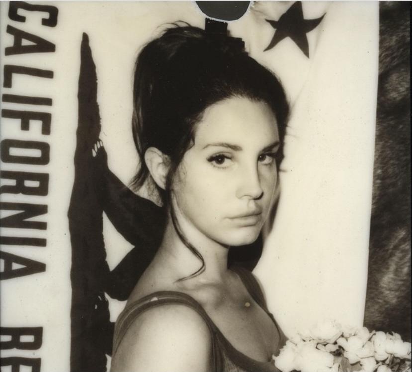 Del Rey poses at her home in Los Angeles in 2015 in front of the California flag, matching her aesthetic as an artist. Del Rey is originally from Manhattan, N.Y., but when her career began, she decided to personify LA.