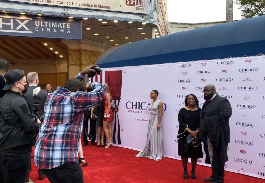 Photographers snap photos of Donovan Price, a respected speaker in Chicago, and his family while on the red carpet at the documentary's premiere in Westwood, Calif. on May 6. Price was a trusted voice for victims, families and Chicago neighborhoods in crisis due to violence. Photo by Beth Gonzales
