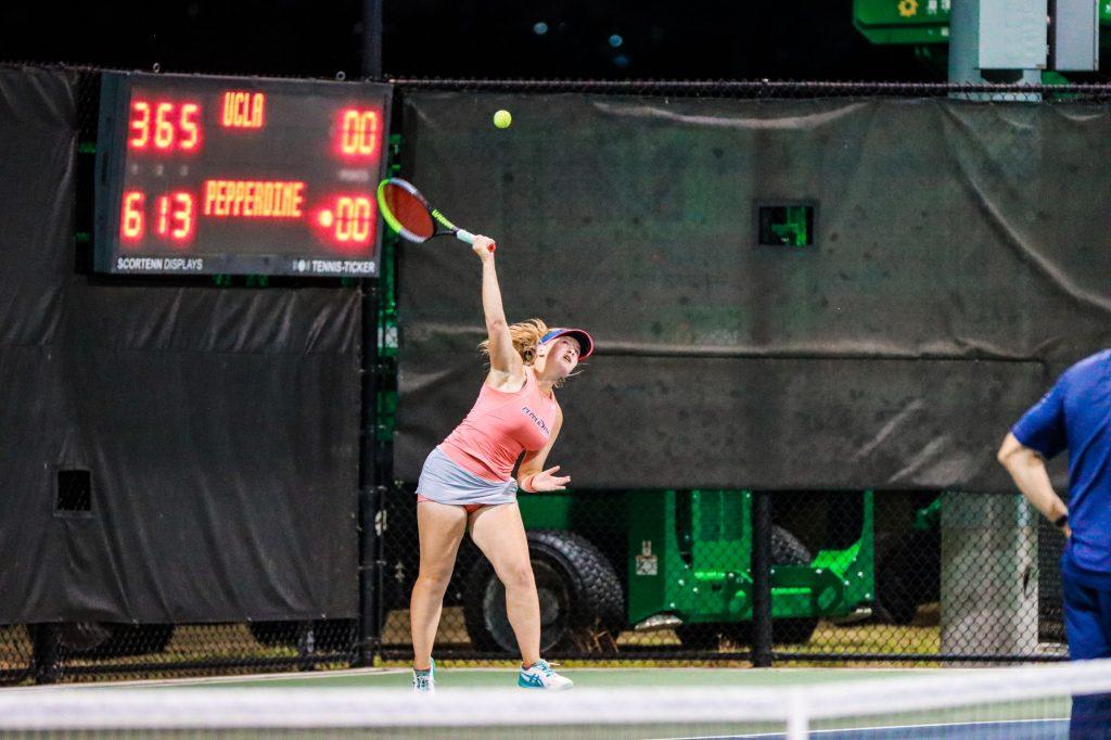 Pepperdine freshman Taisiya Pachkaleva serves against UCLA junior Elysia Bolton during their singles match on court three. Pachkaleva won the match 6-3, 1-6, 7-5. Photo Courtesy of Morgan Davenport | Pepperdine Athletics