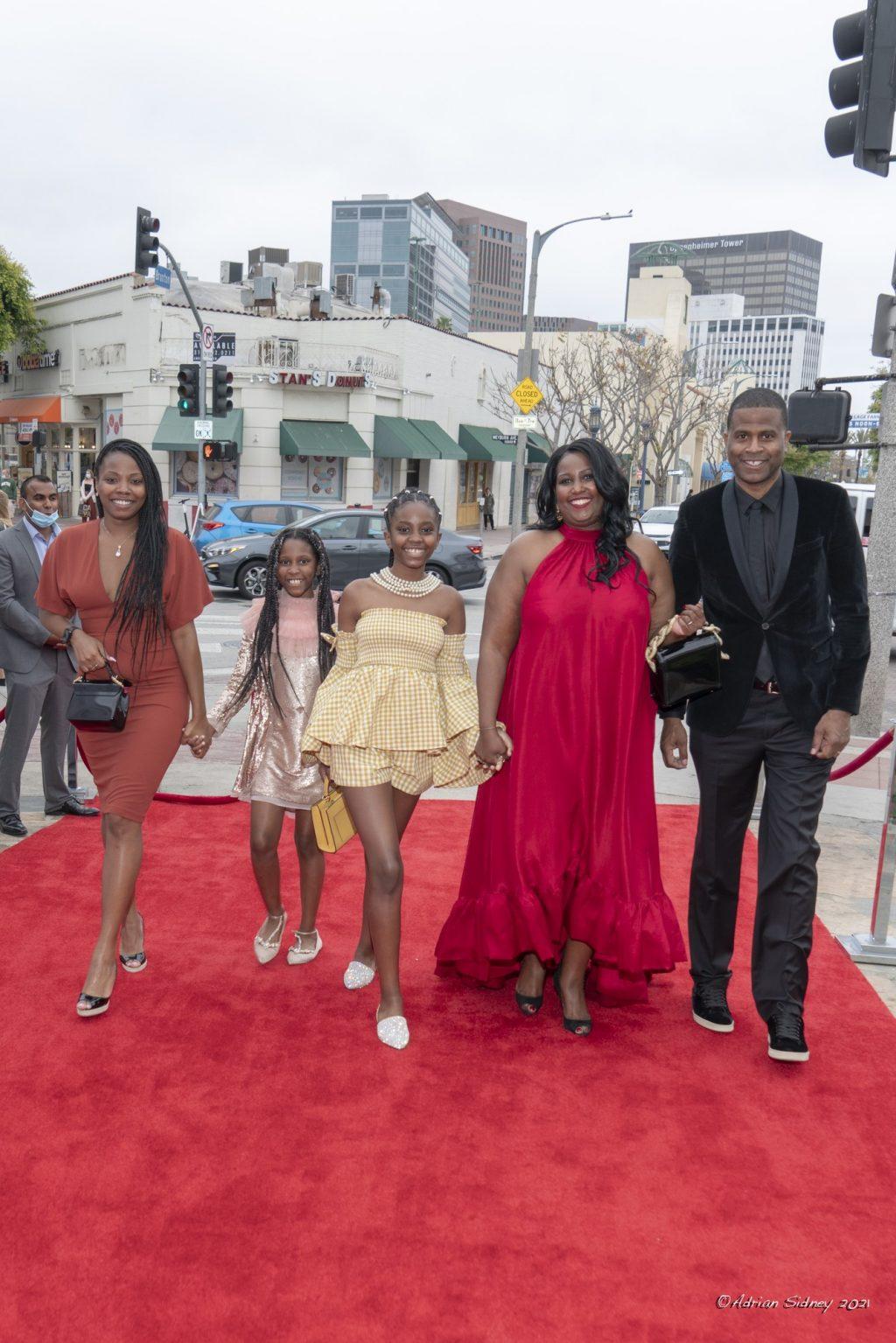Director Daylight Supreme smiles with his family and producer Tiffany Salaberrios as they walk the red carpet before the film starts. His kids were in the film as the documentary added personal touches to the New York native's life. Photo by Adrian Sidney