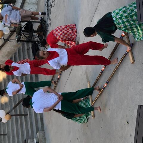 Riley (in red) performs tinikling, a traditional Philippine folk dance, with other members of the Pilipino American Student Association on Heritage Night in the amphitheater on campus in October 2019. Riley said her overall Pepperdine experience has been enjoyable.