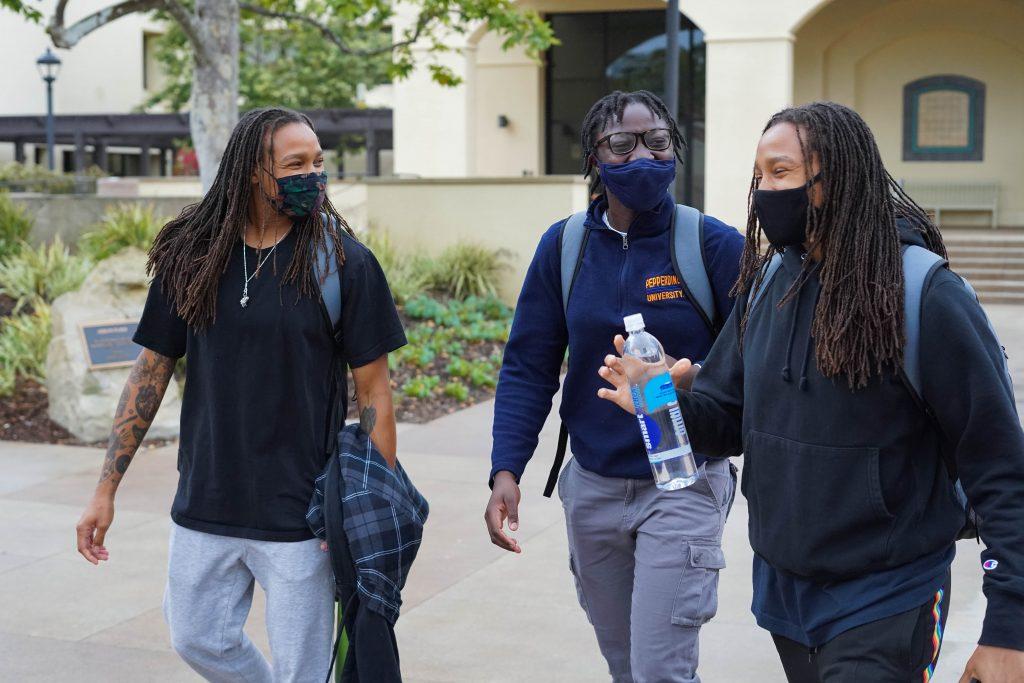 Pepperdine seniors Jayla Ruffus-Milner (left) and Jayda Ruffus-Milner (right) and sophomore Jane Nwaba (center) walk across Mullin Town Square on Monday morning. The Ruffus-Milner twins are taking a French class in Summer Session I, and Jayda Ruffus-Milner is also taking a World Religions class, while Nwaba is taking Spanish.