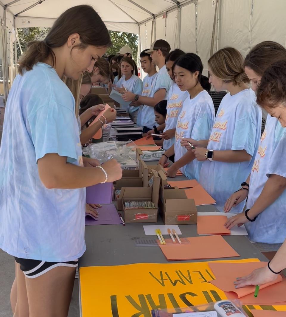 Sophomore Madilyn Henshaw works with other Jumpstart volunteers to put together school supply kits for preschool and kindergarten students. Students came together on the first in-person Step Forward Day since 2019 to do hands-on service activities.