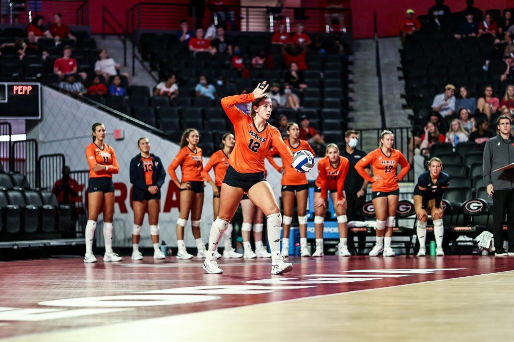 Meg Brown begins a serve with her teammates looking on. Brown entered this season coming off an impressive freshman campaign where she was named WCC Freshman of the Year and All-WCC first team.