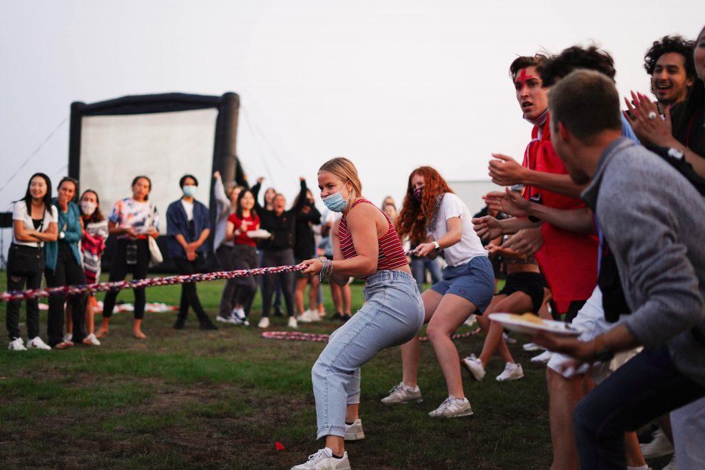 Lausanne program alumni compete in the tug-o-war at the Return as students cheer on. The competition and the Return itself brought together many members of the Class of 2022, who studied abroad their sophomore year and whose programs were cut short due to the COVID-19 pandemic.