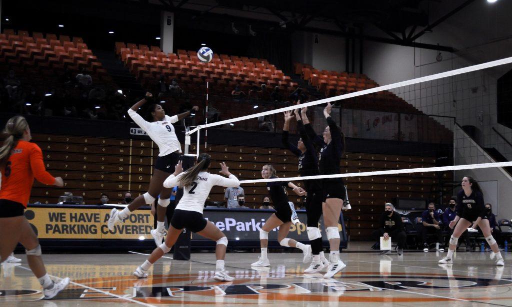 Senior middle blocker Rosie Ballo spikes the ball against the Huskies. Ballo finished the match with six kills and two blocks.