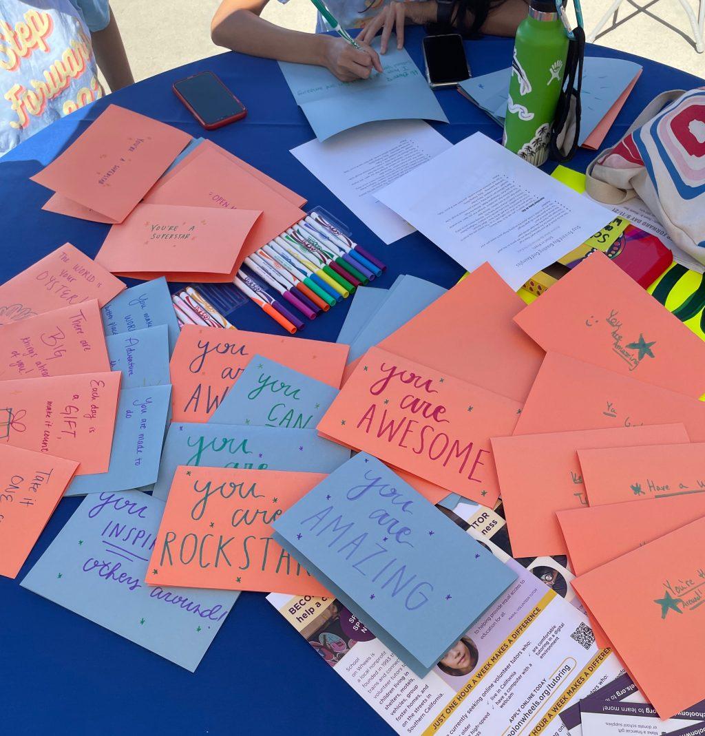 Students write positive messages to be put in supply kits for children and families in need. The directors of Step Forward Day put extra budget money into supplies this year rather than using it to take all students off campus.