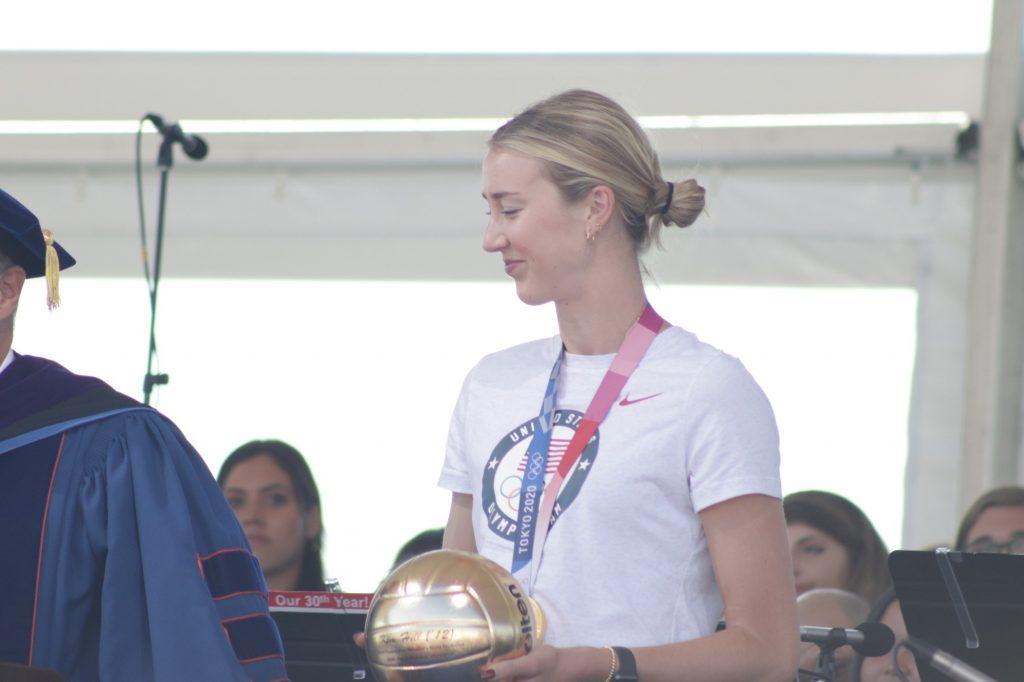 Hill receives a golden volleyball from President Jim Gash to celebrate her achievements after graduating from Pepperdine in 2012. Hill attended Founder's Day to celebrate the University and return to her alma mater after her victory in the 2020 Tokyo Olympics. Photo by Denver Patterson