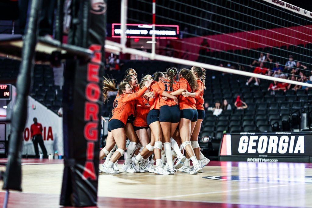 The Waves celebrate after winning the fifth set 15-11. The win secured the match and a perfect 3-0 record in the opening weekend.