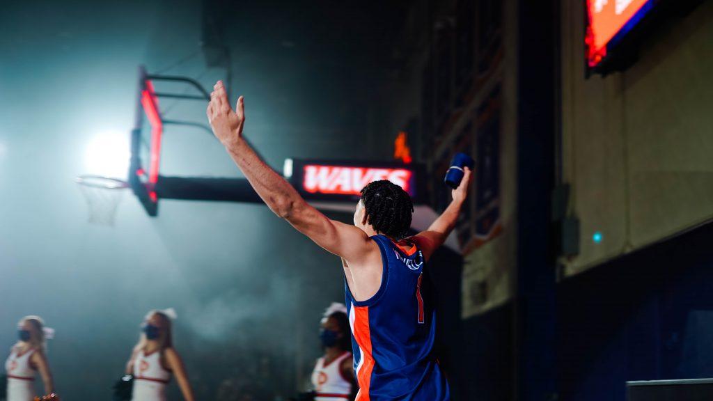 Men's basketball player Mike Mitchell Jr., raises his hands to cheer on his teammates at Blue and Orange Madness. Each year, the University holds the pep rally to get students, parents and alumni excited about the upcoming basketball season. Photo by Dane Bruhahn