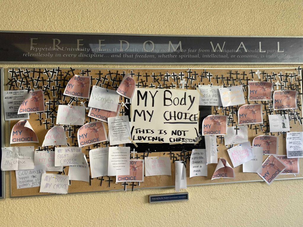 Pepperdine's Freedom Wall holds a variety of opinions as more students engage with the initial anti-abortion posting. Students said they chose to post over the sign to offer support for women and their reproductive rights. Photo by Samantha Torre