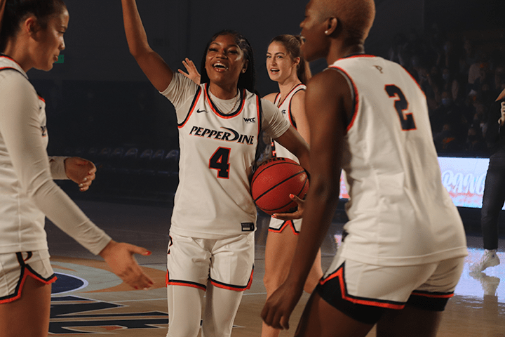 Senior guard Cheyenne Givens hypes up the crowd for the three-point contest. Women's Basketball Head Coach Kristen Dowling said that this was her favorite part of the night.