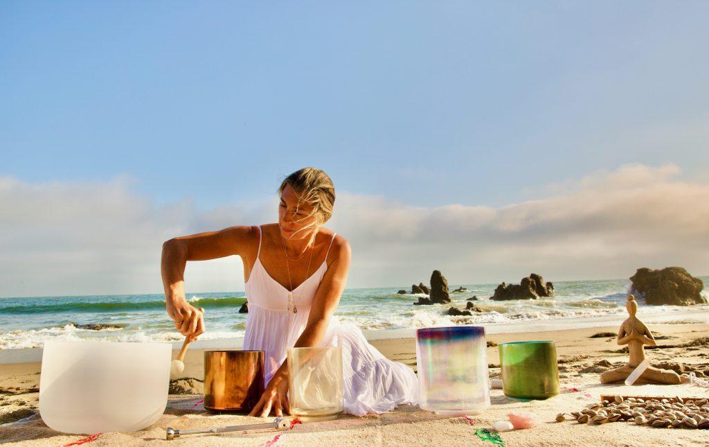 Austin performs a transformative sound bath with bowls made of various crystals. Austin said she started working by the ocean to deepen the connection between the soul, the crystals and the Earth. Photo courtesy of Dana Austin