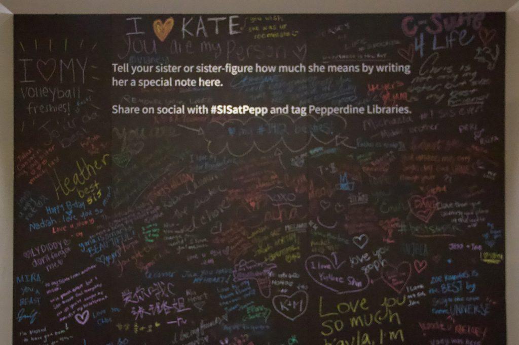 One of Wright's distinct displays encourages students to show their love for their sisters on this blackboard. This inspired students to post pictures of the wall with #SISatPepp. Photo by Chloe Chan