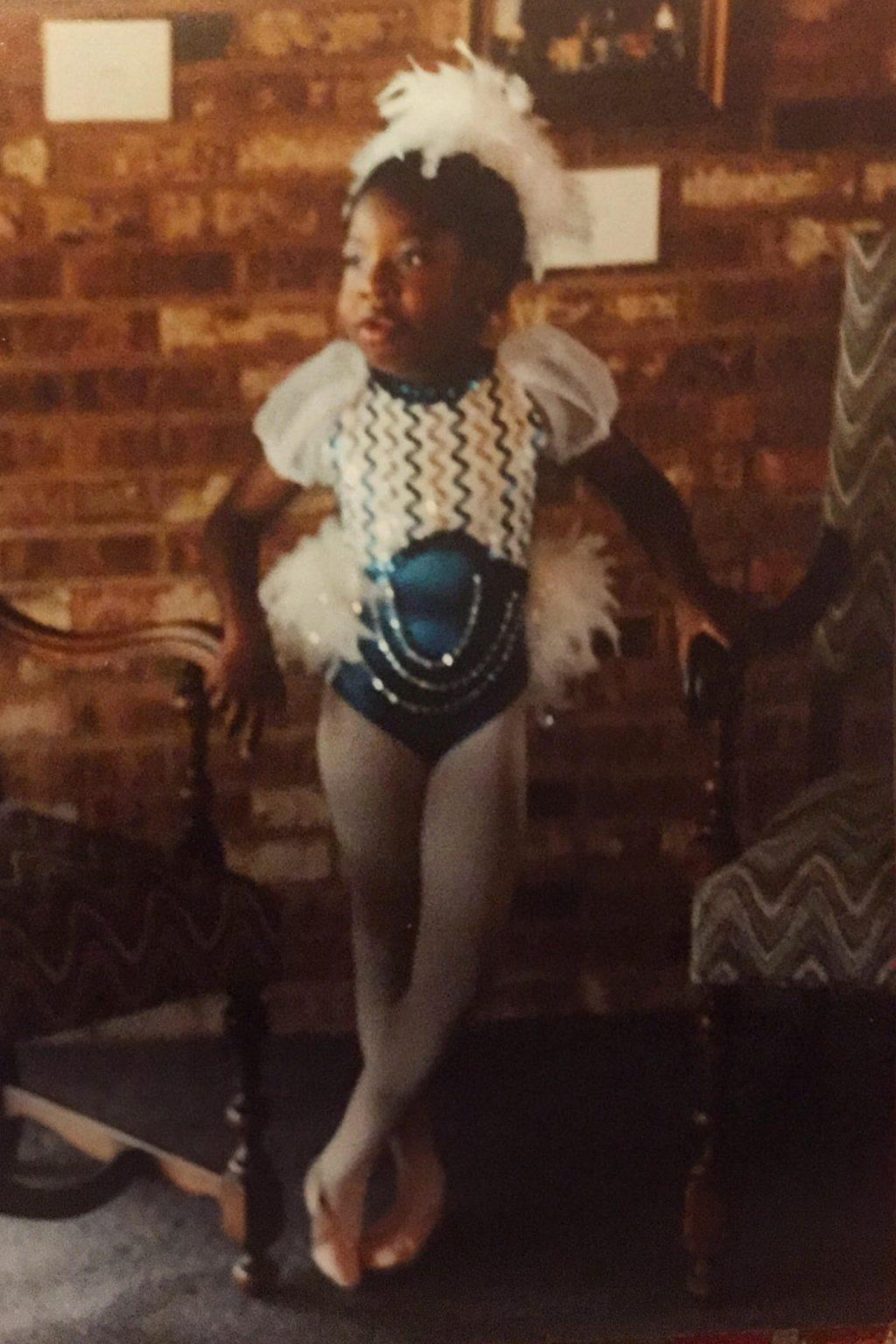 A young Gray poses in her unitard awaiting a performance. She has always loved being in the spotlight and entertaining. Photo courtesy of Jaz Gray