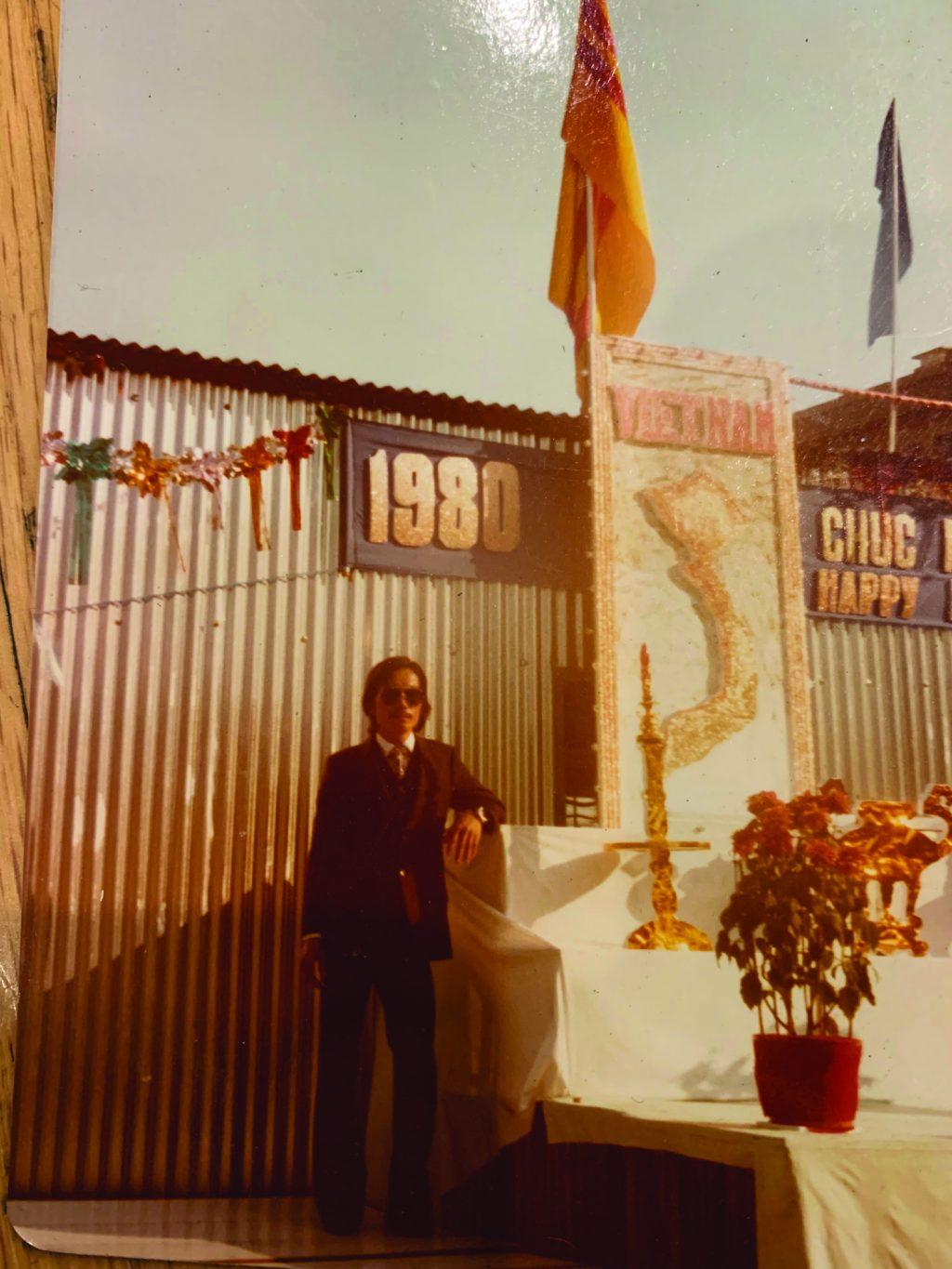 Kat Le’s maternal grandfather, Binh Vu Pham, stands next to an altar of flowers in Da Nang, Vietnam.