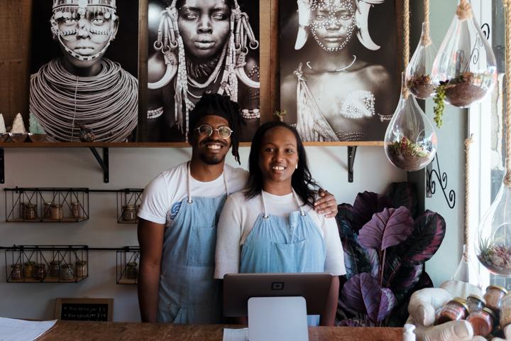 The founders and owners of Flavors from Afar, Christian and Meyuna, pose in their restaurant in Little Ethiopia, LA. Every month, the restaurant hires refugees to cook their native dishes.