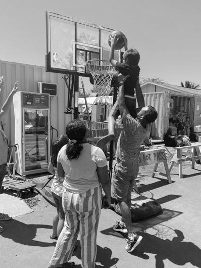 A group in O’ahu, Hawai’i, plays basketball while junior Joe Karlous visited the commuinty. Photo courtesy of Joe Karlous