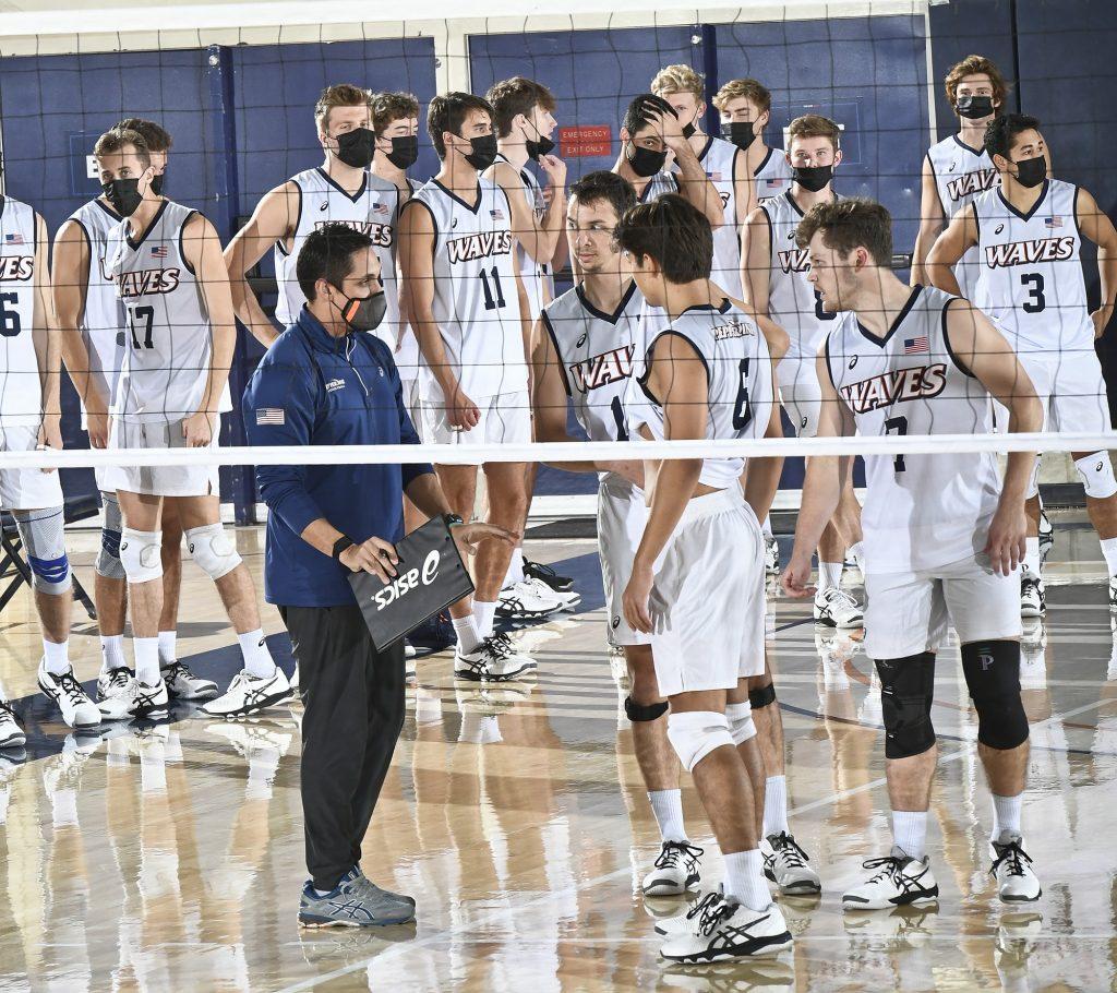 Head Coach David Hunt huddles his team during a game in the 2021 season. Hunt is entering his fifth season as the Men's Volleyball head coach.