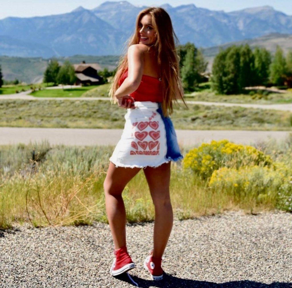 Tomlinson smiles in front of the mountains of her hometown, Jackson, Wyo. in summer 2021. This mountain scenery is featured in many photos found on Tomlinson's public Instagram @katemarietomlinson. Photo courtesy of Kate Tomlinson