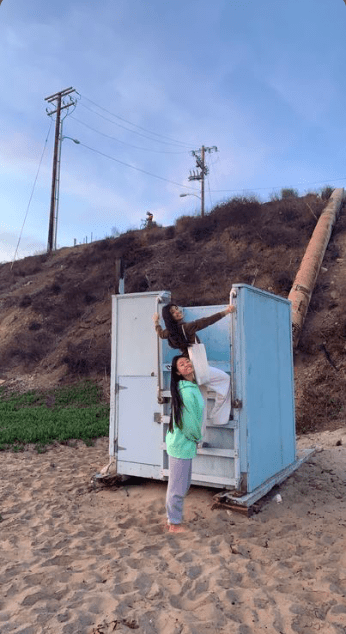 First-years Jessica Qiu and Destinee Cenita climb the life guard tower on Ralphs Beach. The image they created became a photo Caine never knew she needed. Photo Courtesy of Catie Caine