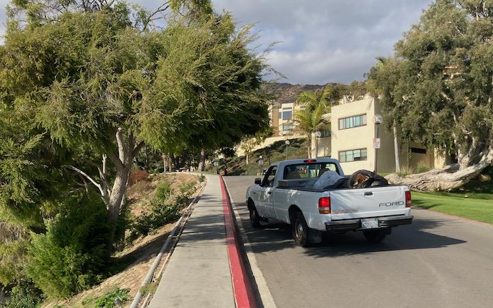 A Facilities truck makes the rounds collecting trash from Dorm Road on a Saturday. Custodians had to work over the weekend this semester.