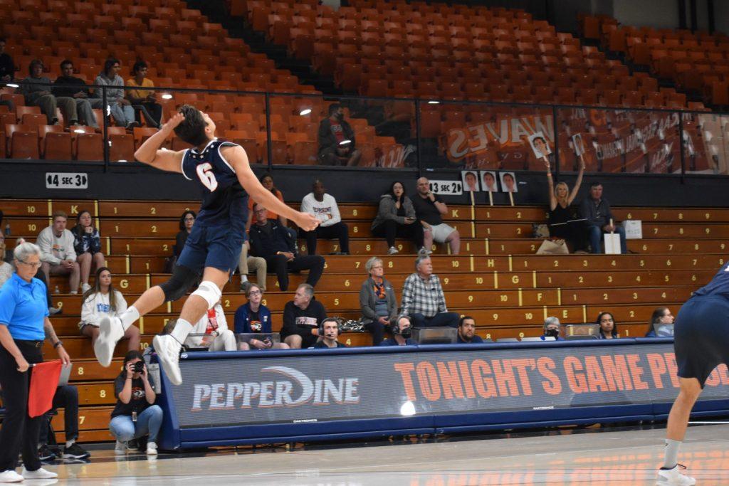 Sophomore setter Bryce Dvorak jump serves . Dvorak leads the team with 31 service aces in the season. Photo by Mary Elisabeth