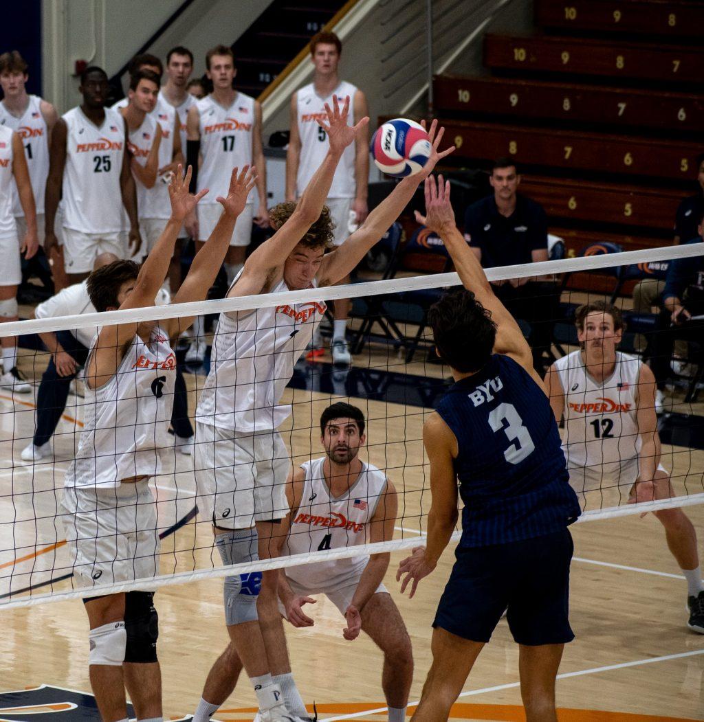 Graduate student middle blocker Austin Wilmot joins sophomore setter, Bryce Dvorak, for a double block in the first contest. The Waves finished the contest with sixteen team blocks.