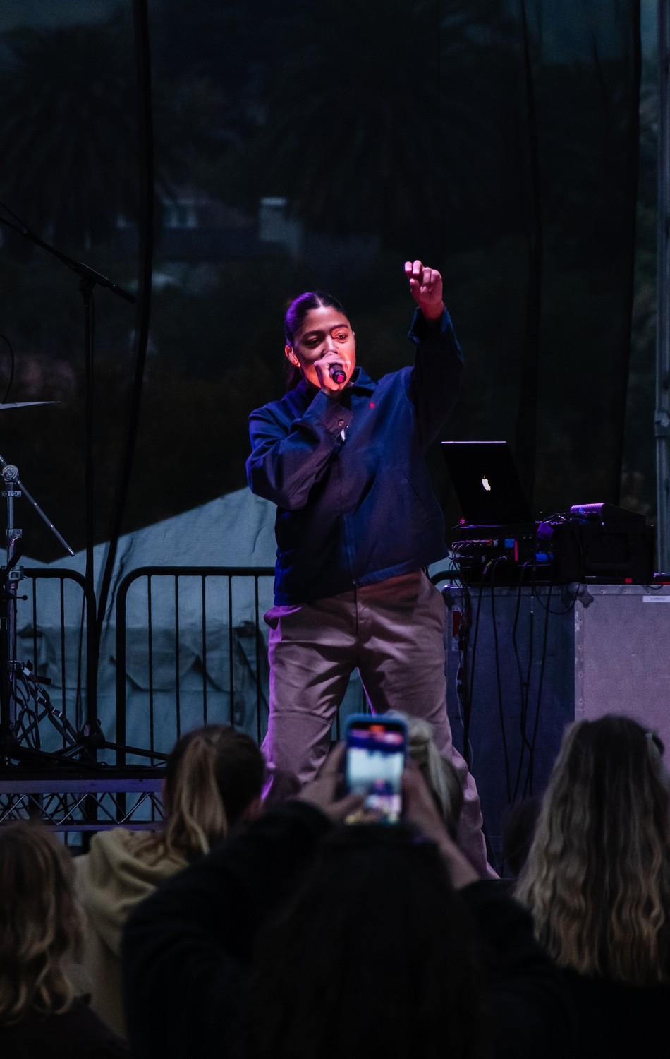 Hope Tala dances as she sings her R&B soul-style music. The crowd of students on Alumni Park gathered at the stage and sang along with friends. Photo by Lucian Himes