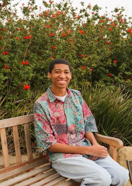 Photo by Caroline Conder | Junior Public Relations major D’artagnon Fulton lounged on a bench near Stauffer Chapel. Fulton identifies as a Black queer person and uses all pronouns.