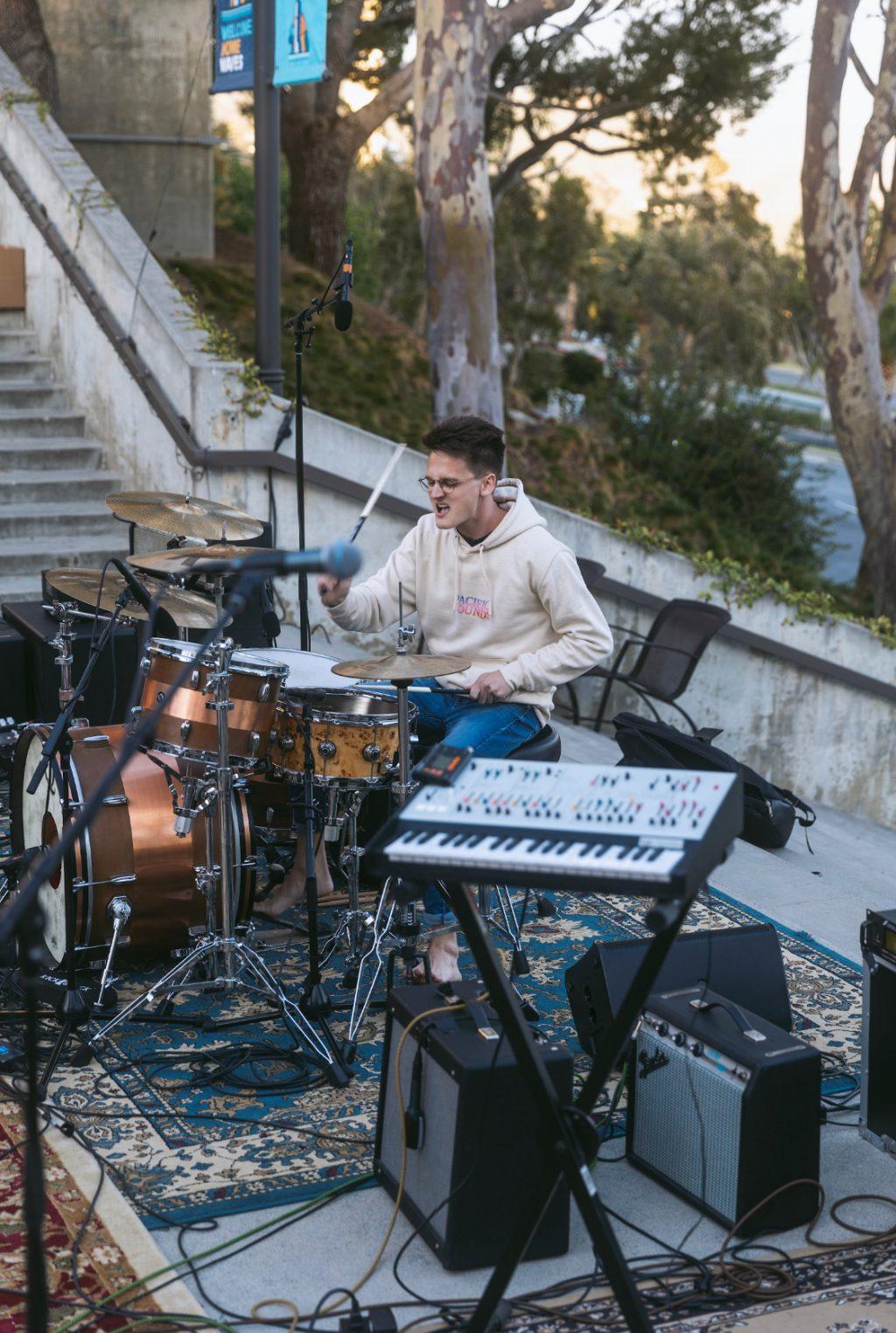 Kohlton Dannenberg plays the drums during Closed Caption's performance at the Pacific Sounds festival on March 19. Woodburn said he has known Dannenberg since the two were first-years.