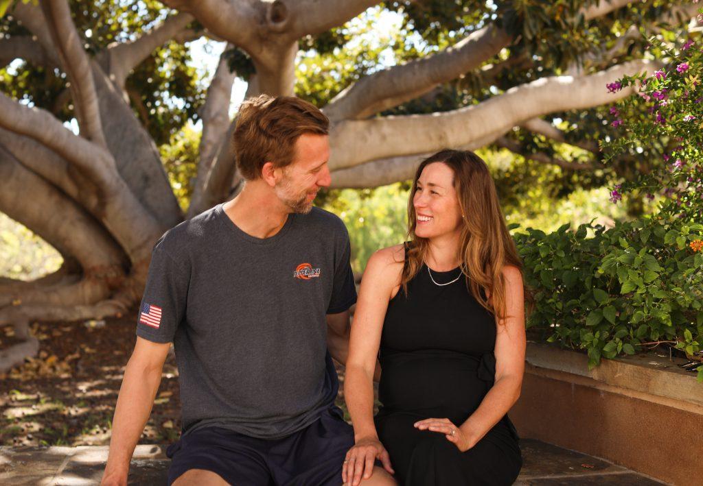 Photo by Caroline Conder | Paul and Erin Carroll (‘09) posed outside Firestone Fieldhouse where they both work for the Athletics Department. They said some of their favorite moments are when they eat lunch together on the tables outside of Firestone Fieldhouse.