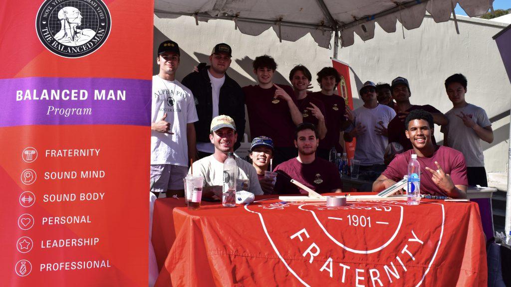 Sigma Phi Epsilon members smile as they group together in front of the tent for spring rush. The fraternity accepted 11 new active members in the Spring 2022 semester. Photo by Mary Elisabeth