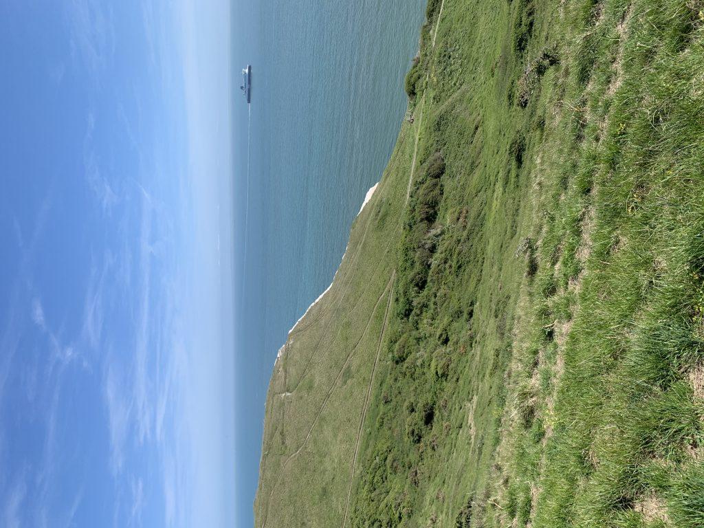 A ship in the distance passes by the Cliffs of Dover, as viewed from the hills above in May. The hills were a wonderful spot for a mid-afternoon nap.