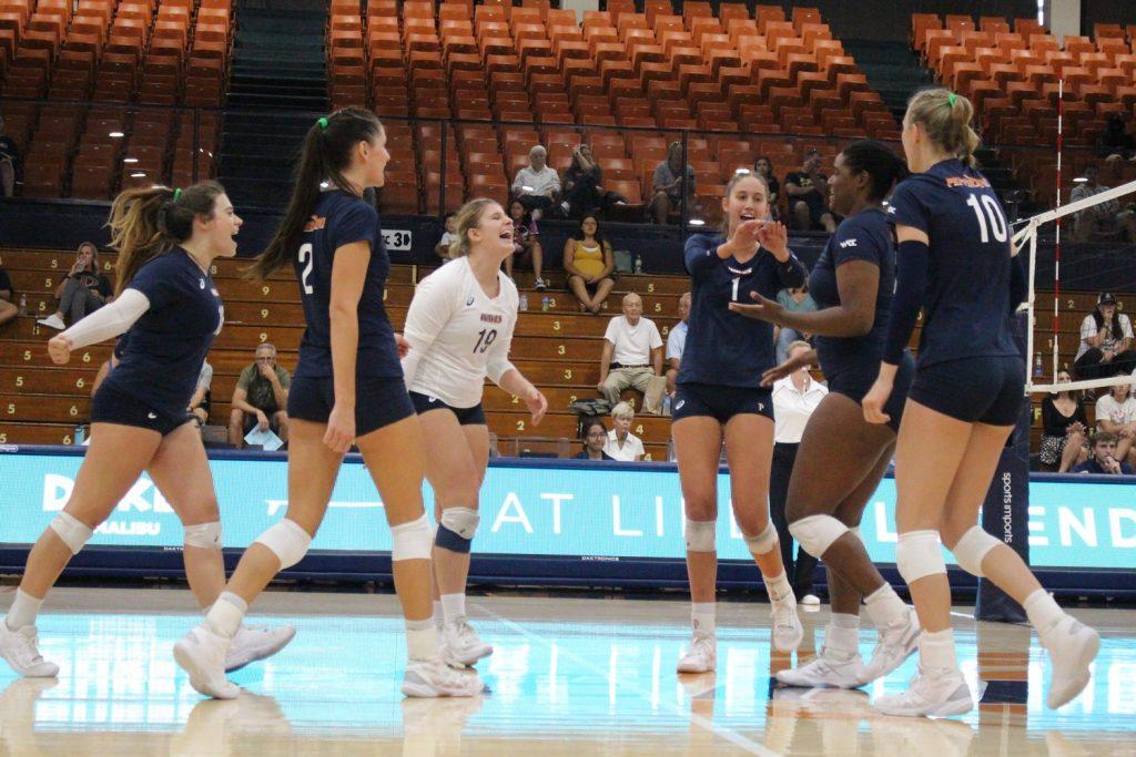 Women's Indoor Volleyball celebrate winning a point during the Pepperdine Asics Classic on Sept. 1-3, at Firestone Fieldhouse. The Waves won all three of their games in the preseason tournament.