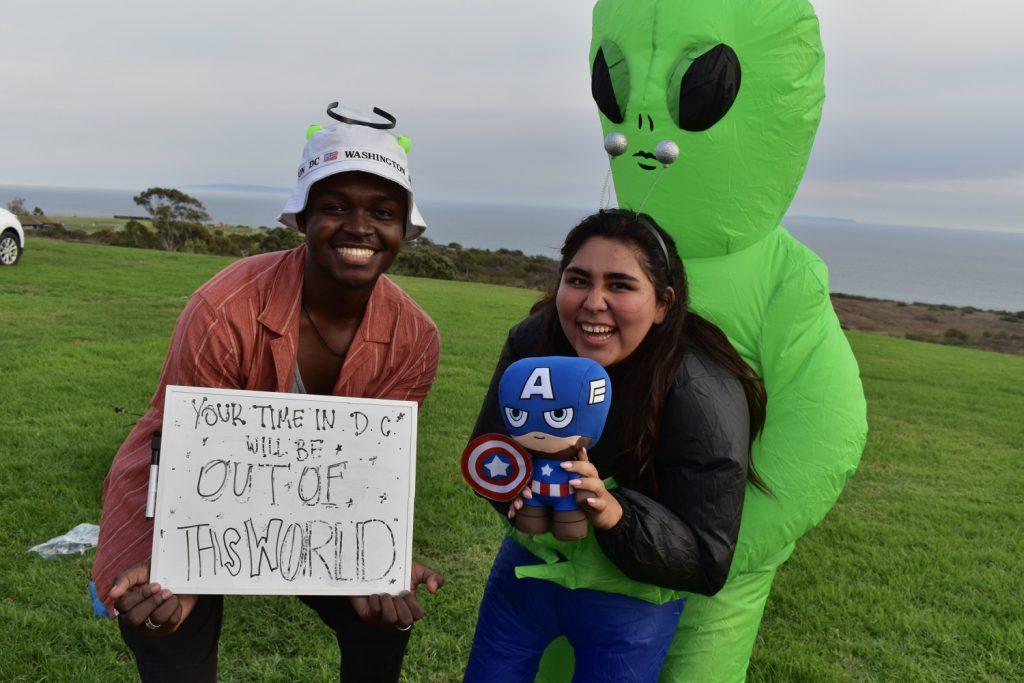 DC smiles with elaborate sign