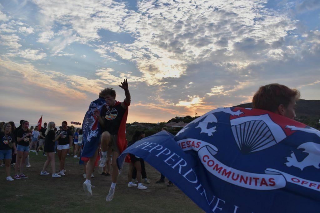 Lausanne returners go for a in air body bump as their flag waves on