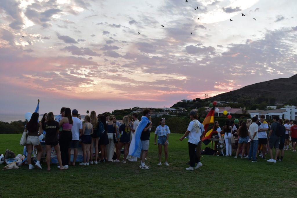 A wide view of the programs tabling as the sun sets behind the mountains
