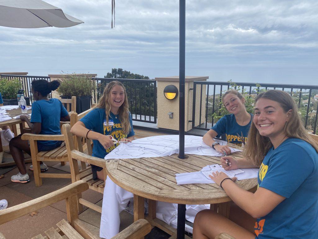 Teammates from the Women's Swim Team are volunteering for Days for Girls. They traced and cut out the inside of a pad with a material that is easy to clean, according to McLeay. Photo by Tanya Yarian