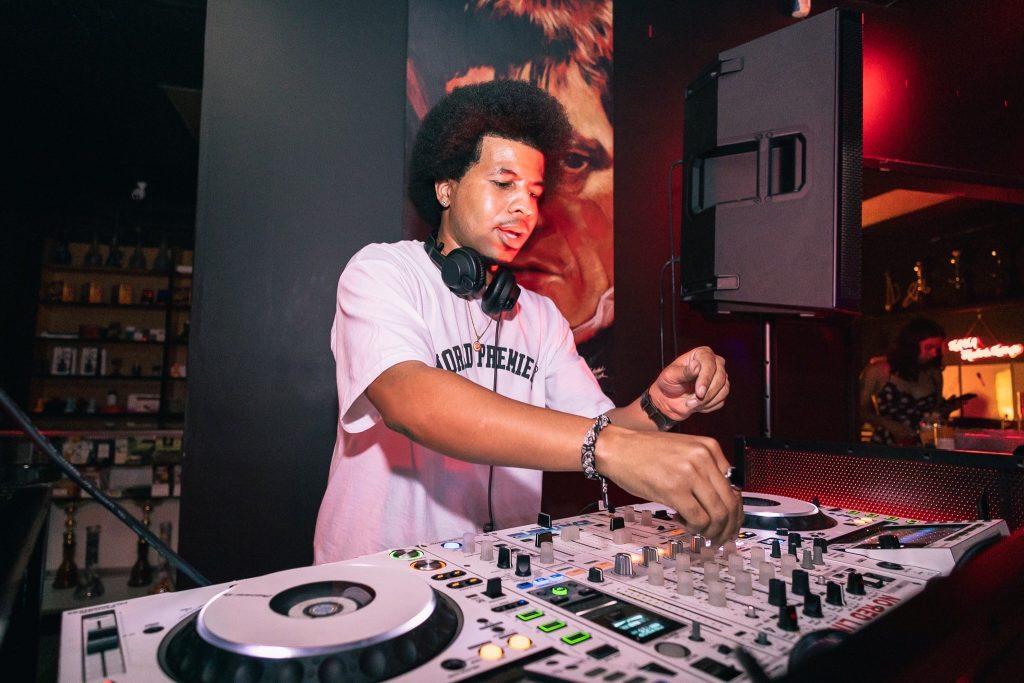 DJ Kevin Romar mixes beats at a nightclub Sept. 6. Romar and senior Asher Witham have a special relationship as both are trying to increase the energy at Firestone Fieldhouse on game days.