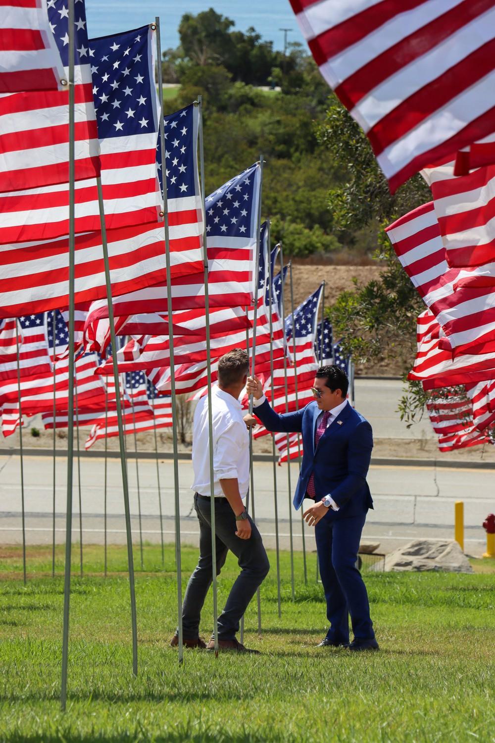 [names], the founders of Waves of Flags, resecure a flag that had been tilted.