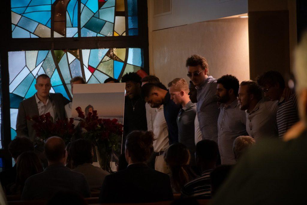 Sig Ep sings after performing a rose ceremony.