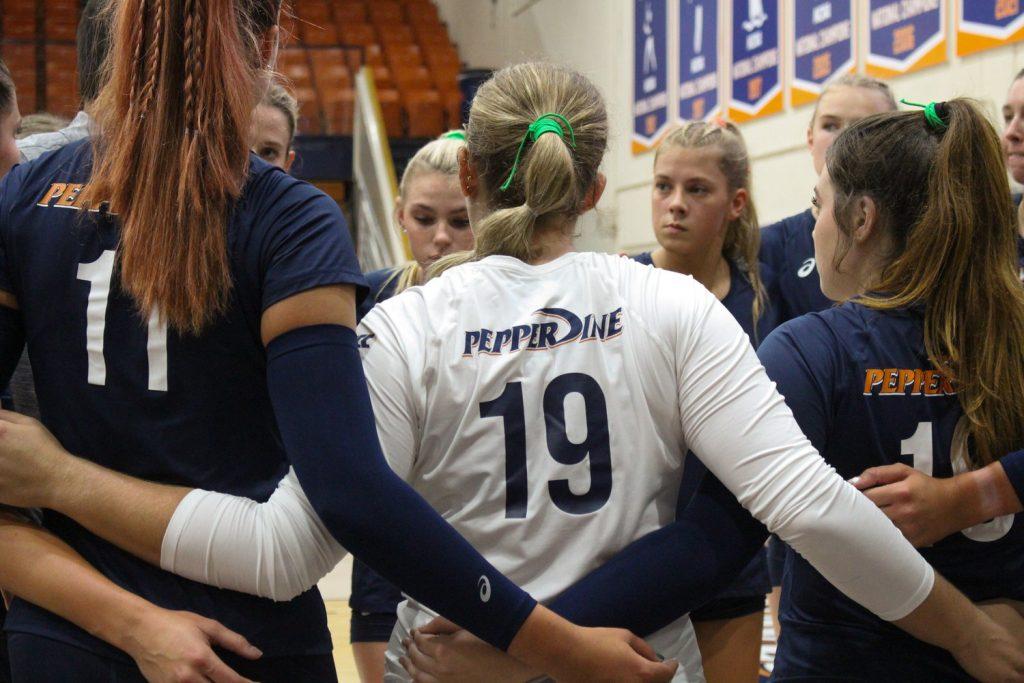The Pepperdine Women's volleyball team is called for a quick meeting as they strategize for the next set. They played against San Diego State University on Saturday, September 6th in Firestone Fieldhouse.