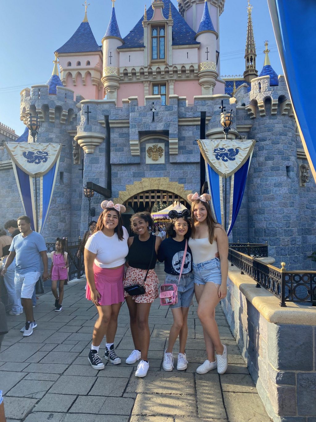 My friends Kim, Kaila, Sarah and I all smile under the castle at Disneyland on Aug. 2. We all got "pixie dusted" right before, which is when a cast member sprinkles glitter on you as you make a wish.
