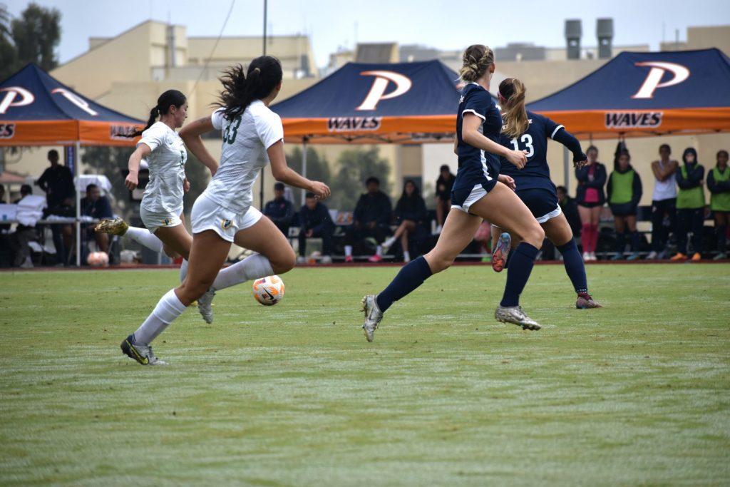 Two Waves defenders, including senior defender Trinity Watson, fall back to counter a San Francisco push Oct. 15 on Tari Frahm Rokus Field. During the second half, their defensive performance denied San Francisco several chances.